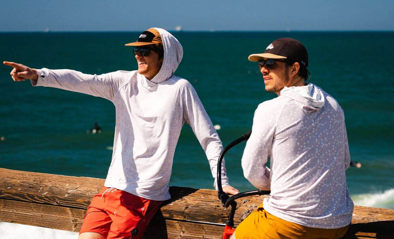 two people on a bike at the beach